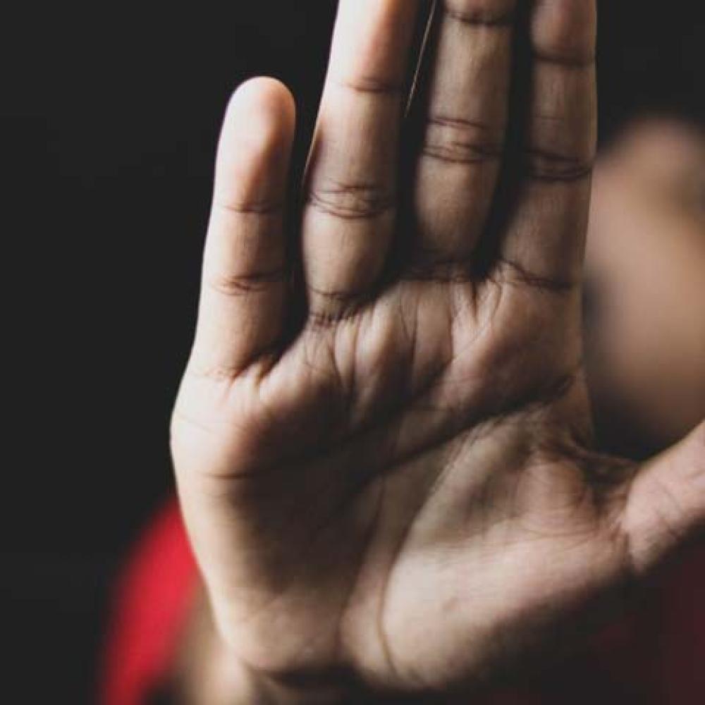 a person holding up their hand as a stop sign